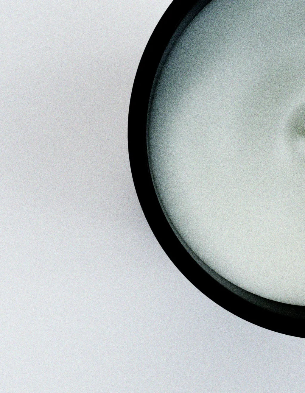 ōtéhà scented candle wax surface in black glass container